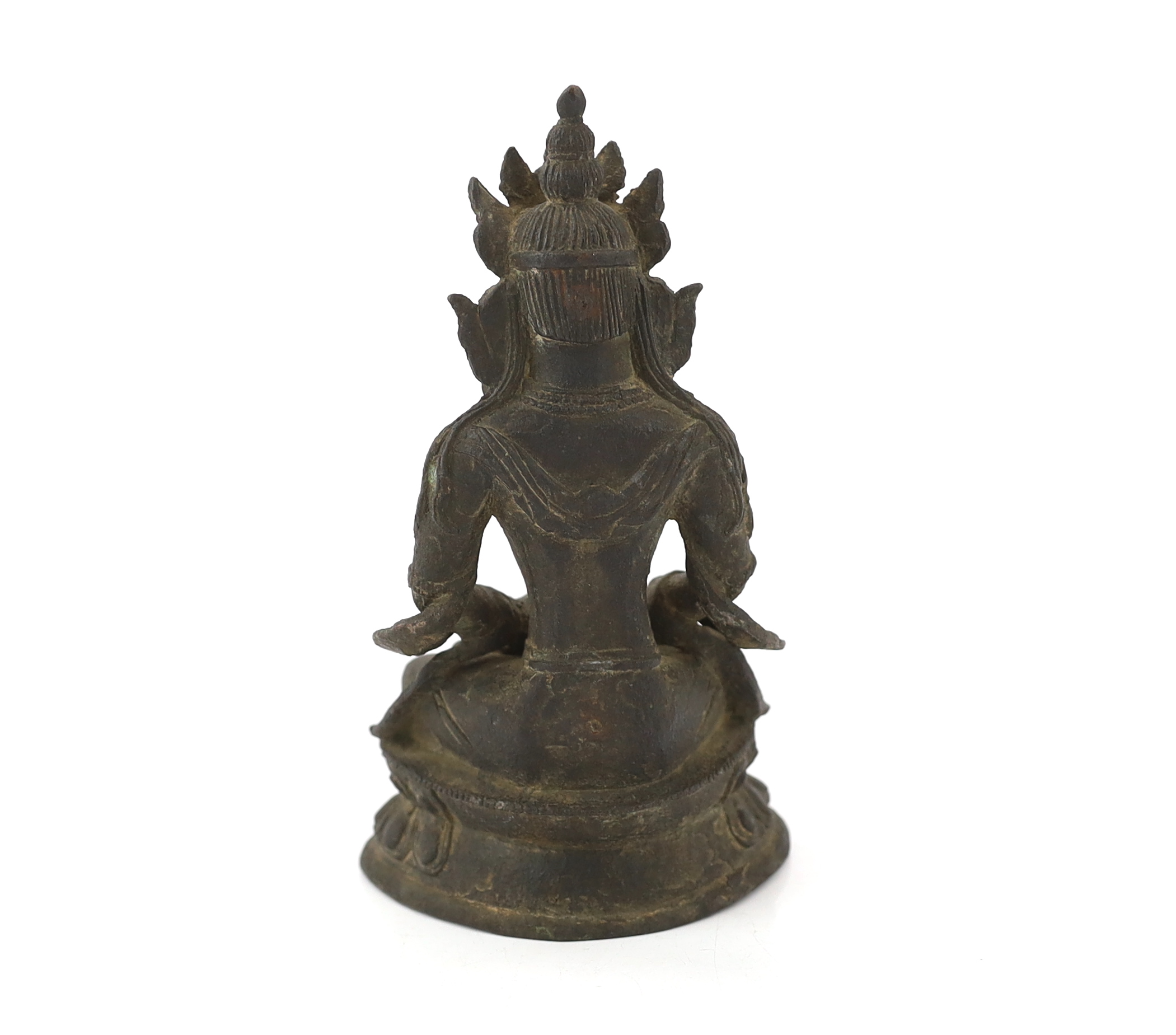 A Chinese bronze seated figure of Amitayus, probably 18th century, surface pitted